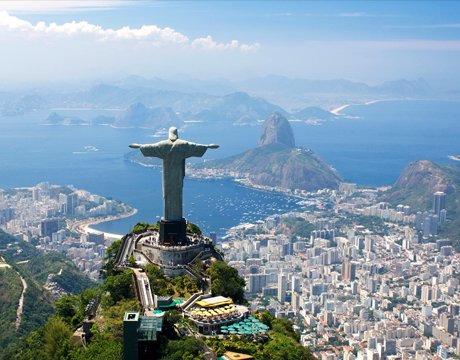 Christ the Redeemer statue overlooking Rio de Janeiro with Sugarloaf Mountain in the background | MSC Cruises