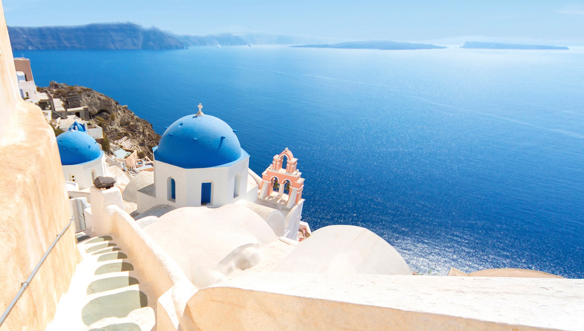 Iconic blue-domed churches overlooking the Aegean Sea in Santorini | MSC Cruises Iconic blue-domed churches overlooking the Aegean Sea in Santorini | MSC Cruises