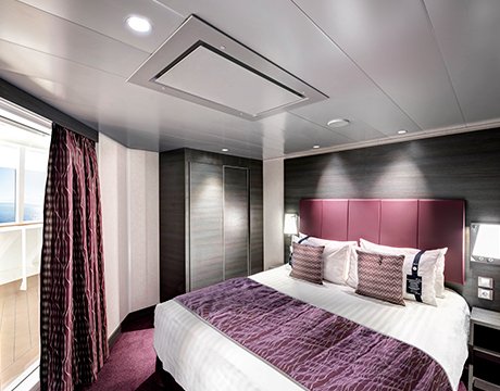 Luxurious cruise cabin with a double bed, purple accents, and a private balcony view | MSC Cruises Luxurious cruise cabin with a double bed, purple accents, and a private balcony view | MSC Cruises