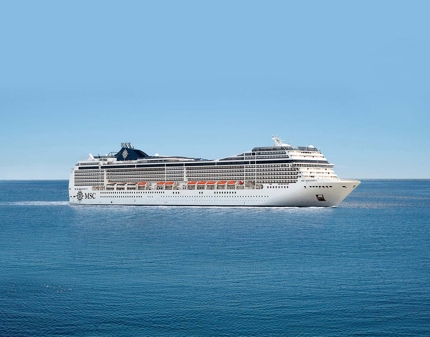 An MSC cruise ship sailing on calm blue waters under a clear sky | MSC Cruises