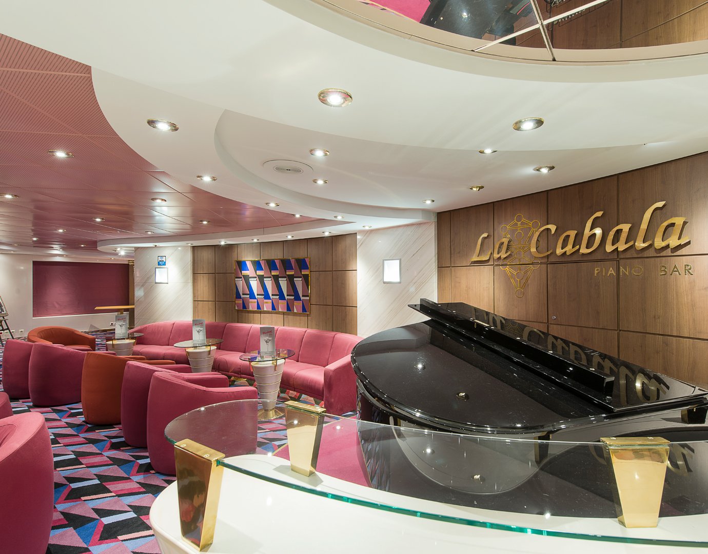 Elegant La Cabala Piano Bar with pink seating and a grand piano onboard an MSC cruise ship | MSC Cruises Elegant La Cabala Piano Bar with pink seating and a grand piano onboard an MSC cruise ship | MSC Cruises