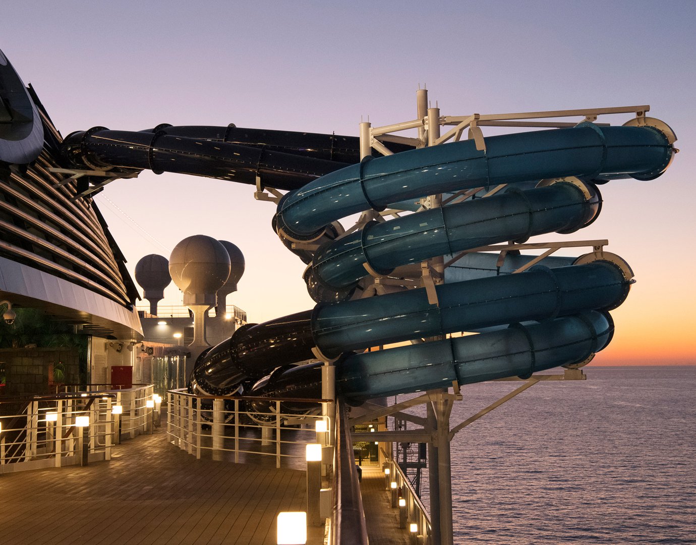 Twisting water slides on an MSC cruise ship at sunset | MSC Cruises Twisting water slides on an MSC cruise ship at sunset | MSC Cruises